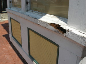 Wood splitting on window trim, likely due to aging paint and freeze/thaw stress
